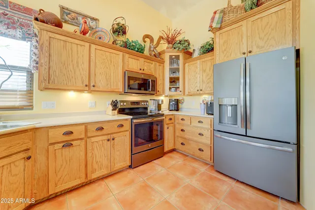 a kitchen with cabinets a refrigerator a stove a washer and dryer