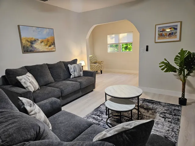 a living room with furniture and a potted plant
