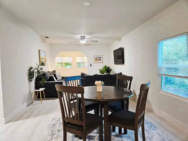 a view of a dining room with furniture and a large window