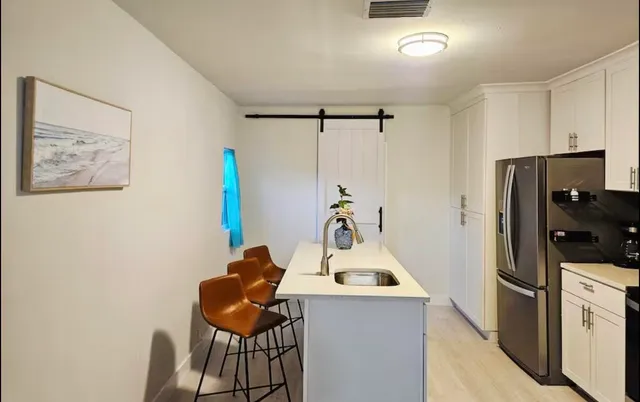 a room with a refrigerator and cabinets