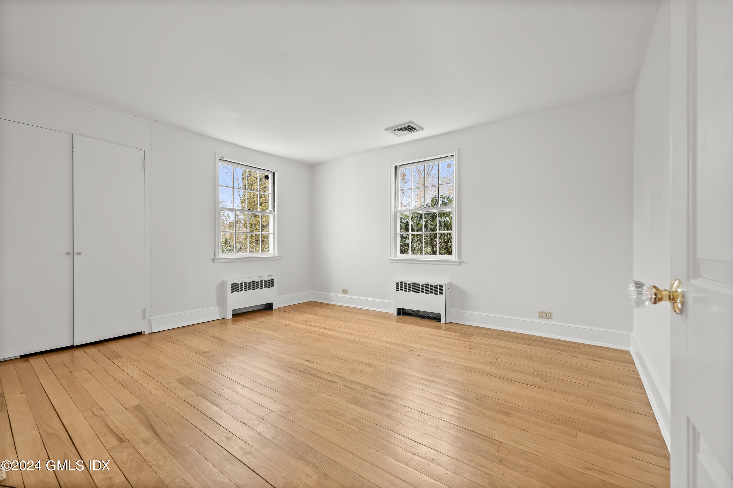 320 Cognewaugh Road Cos Cob, CT 06807 - Photo 11 of 15 an empty room with windows