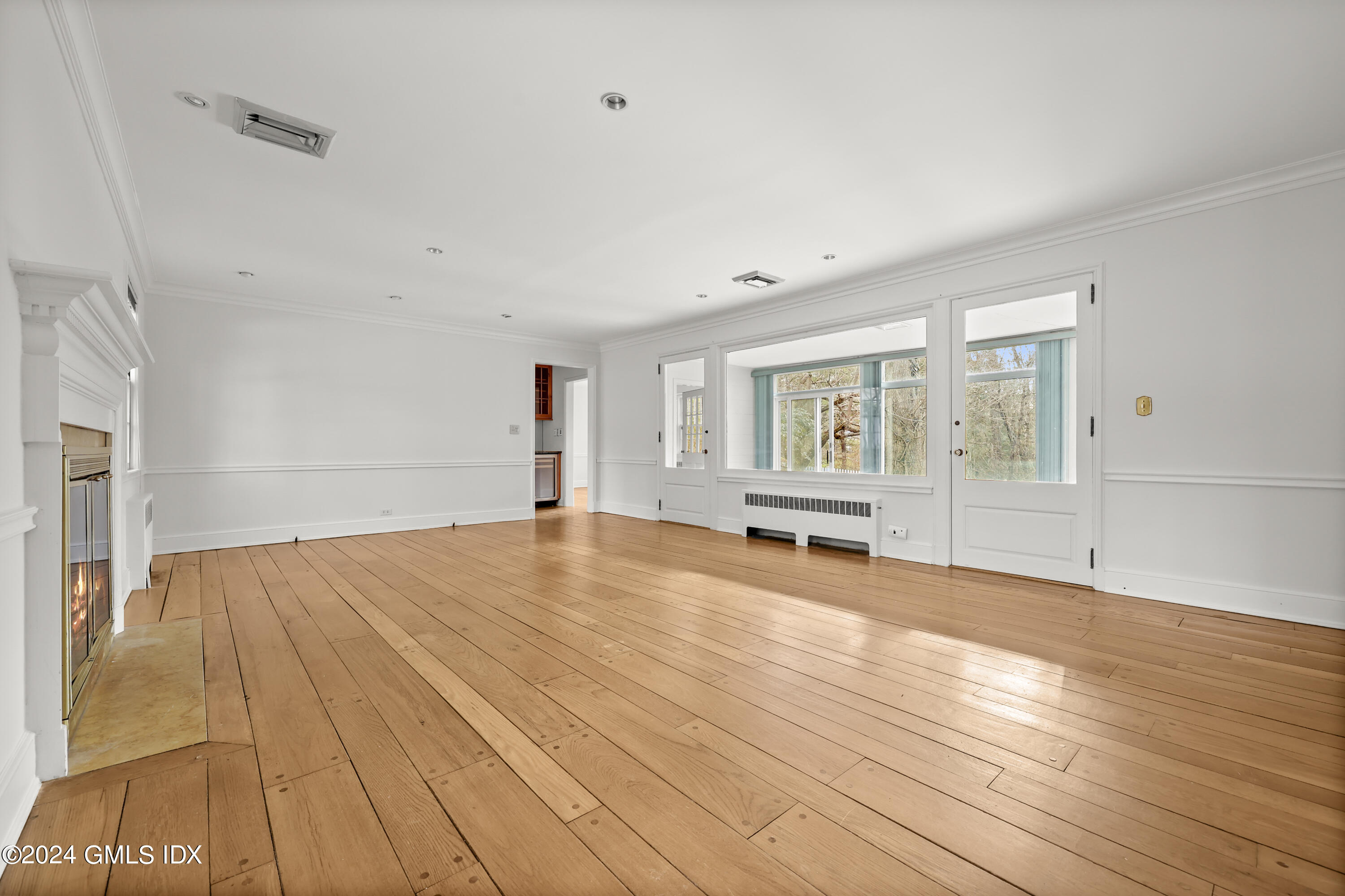 320 Cognewaugh Road Cos Cob, CT 06807 - Photo 12 of 15 an empty room with wooden floor and windows