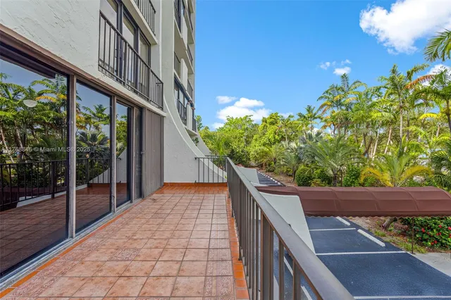 a view of a hallway with wooden floor and a chandelier
