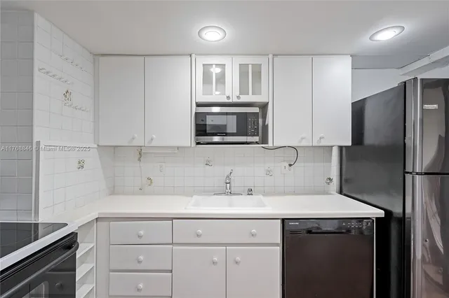 a kitchen with stainless steel appliances granite countertop a stove and a sink