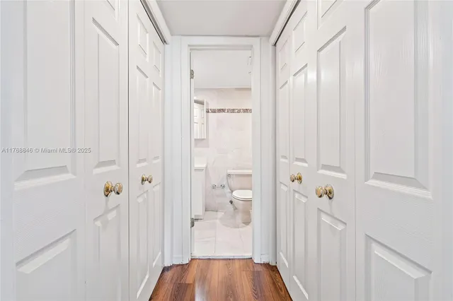 an empty room with wooden floor and window