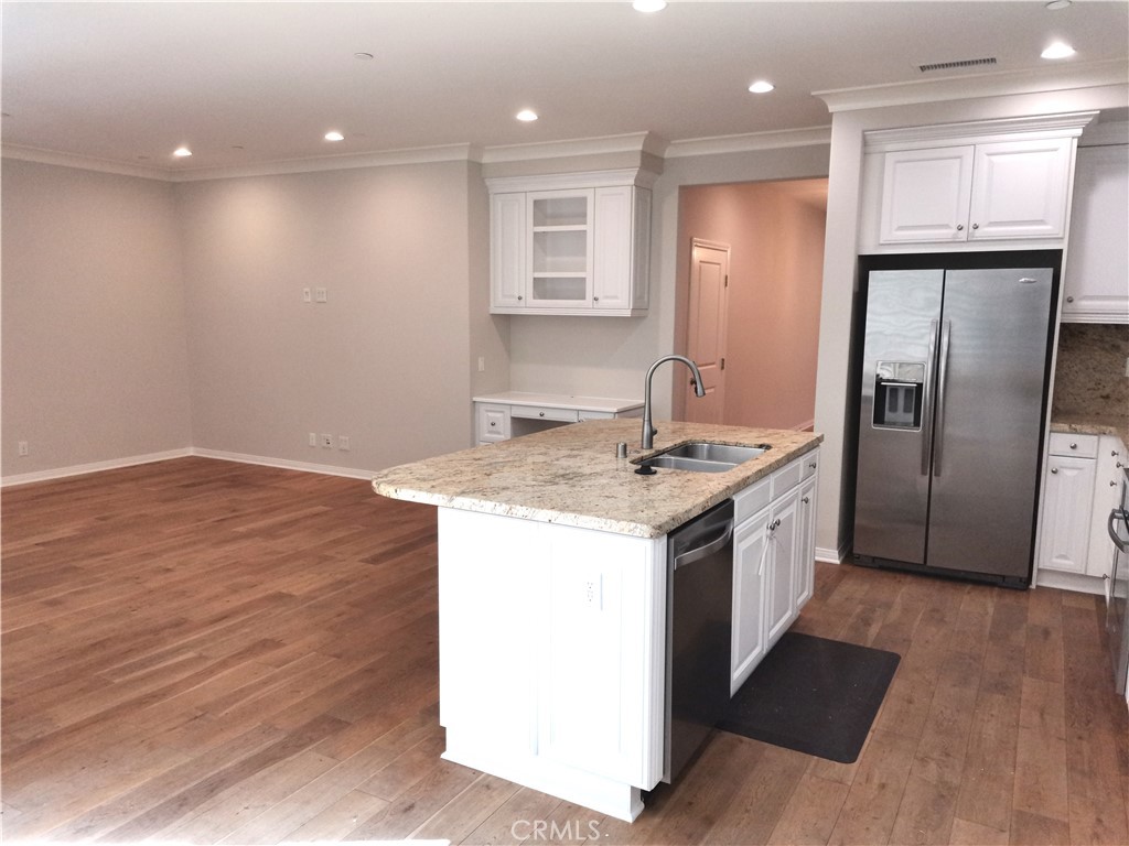 40 Bianco Irvine, CA 92618 - Photo 4 of 6 a kitchen with stainless steel appliances granite countertop a refrigerator a sink and a stove