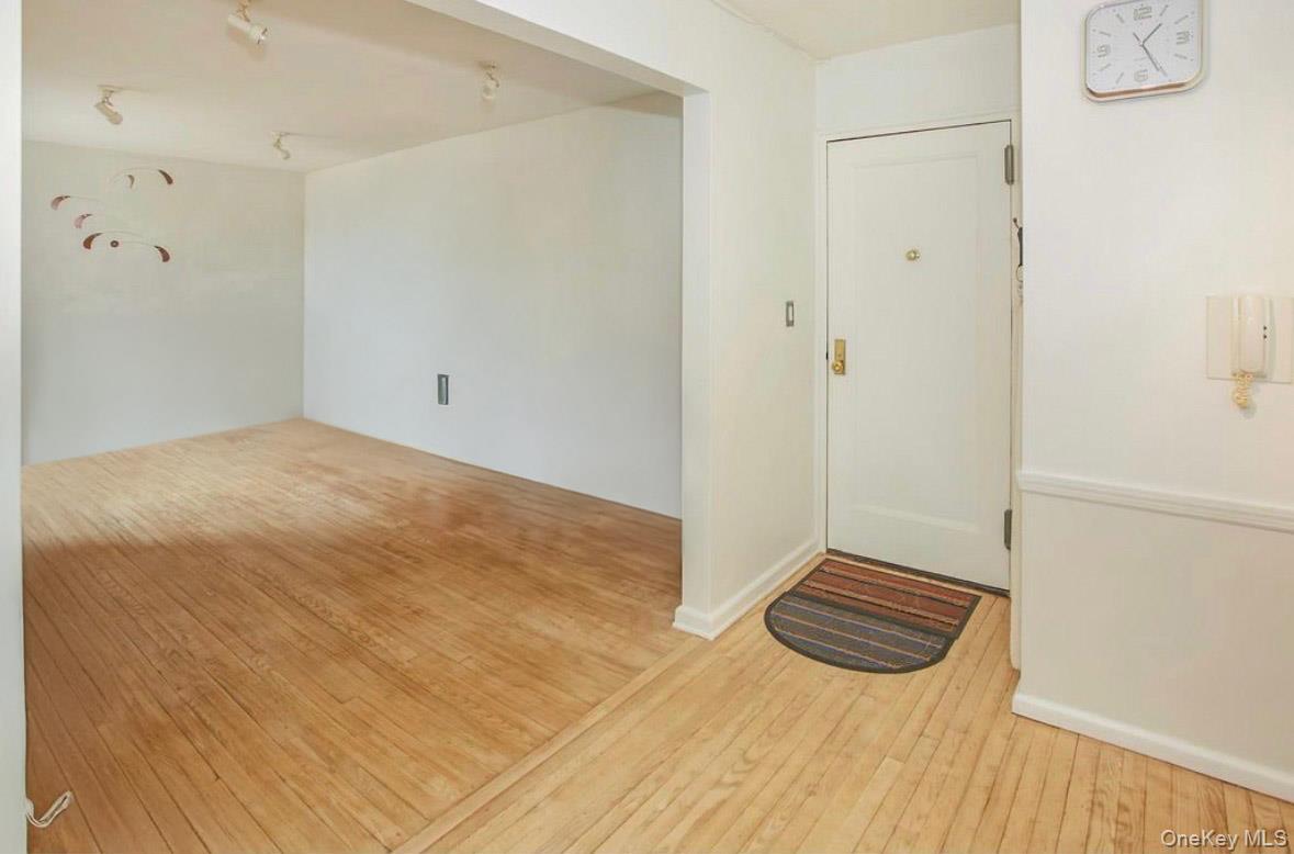 a view of a room with wooden floor