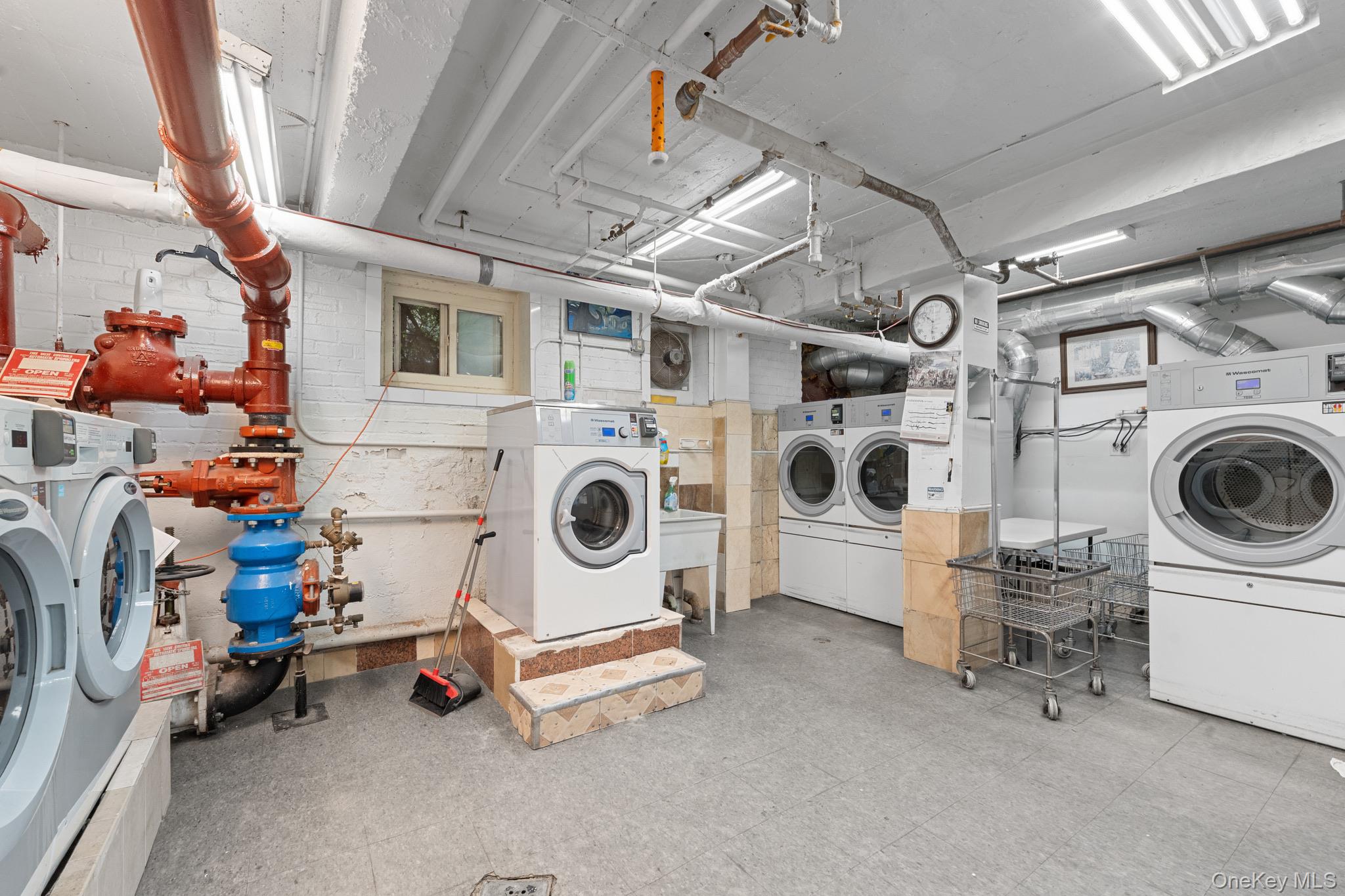 84-35 Lander Street, Unit 2B Queens, NY 11435 - Photo 14 of 16 a utility room with dryer and washer