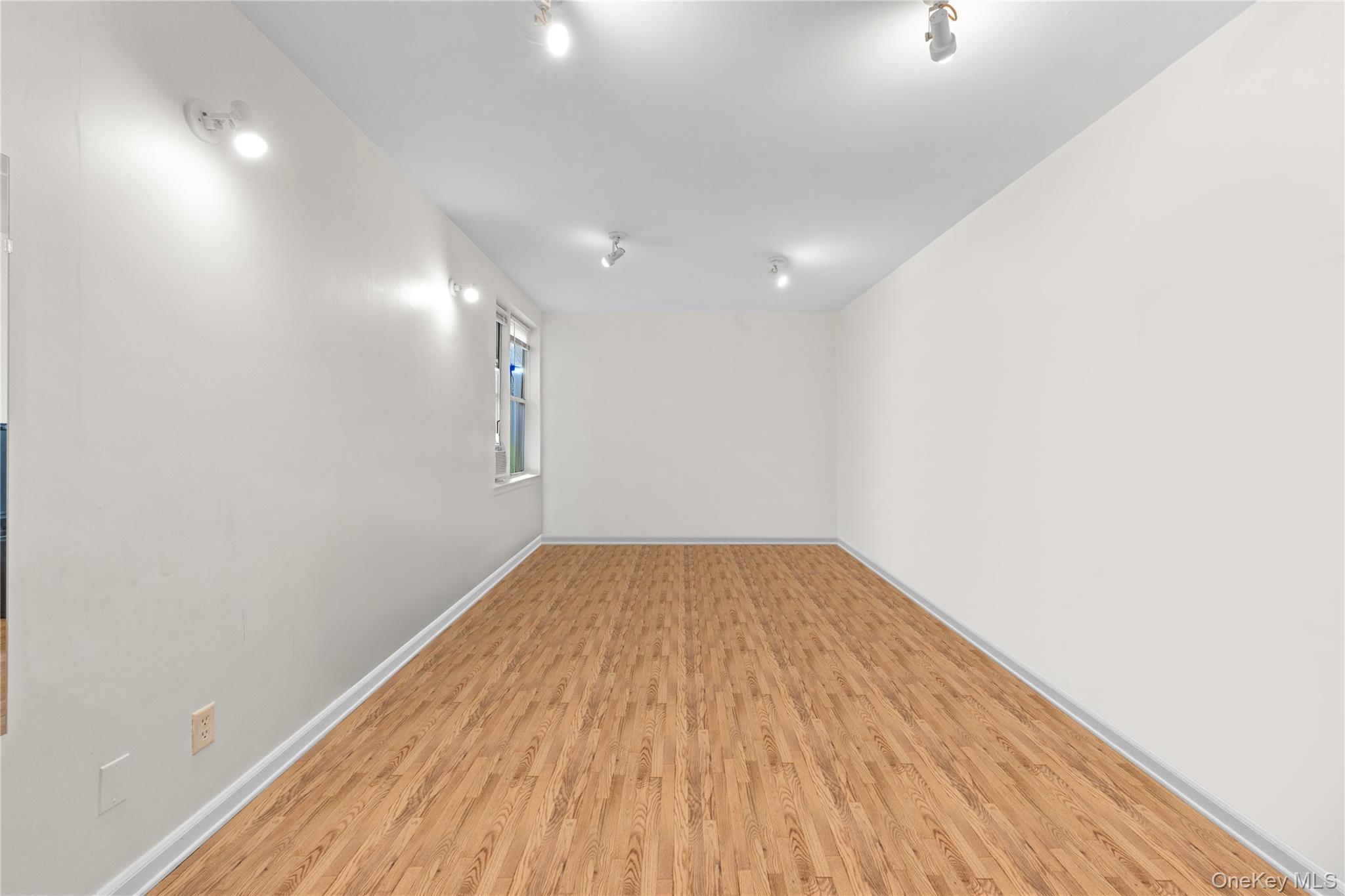 84-35 Lander Street, Unit 2B Queens, NY 11435 - Photo 2 of 16 a view of empty room with wooden floor