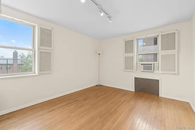 a room with a bed and wooden floor