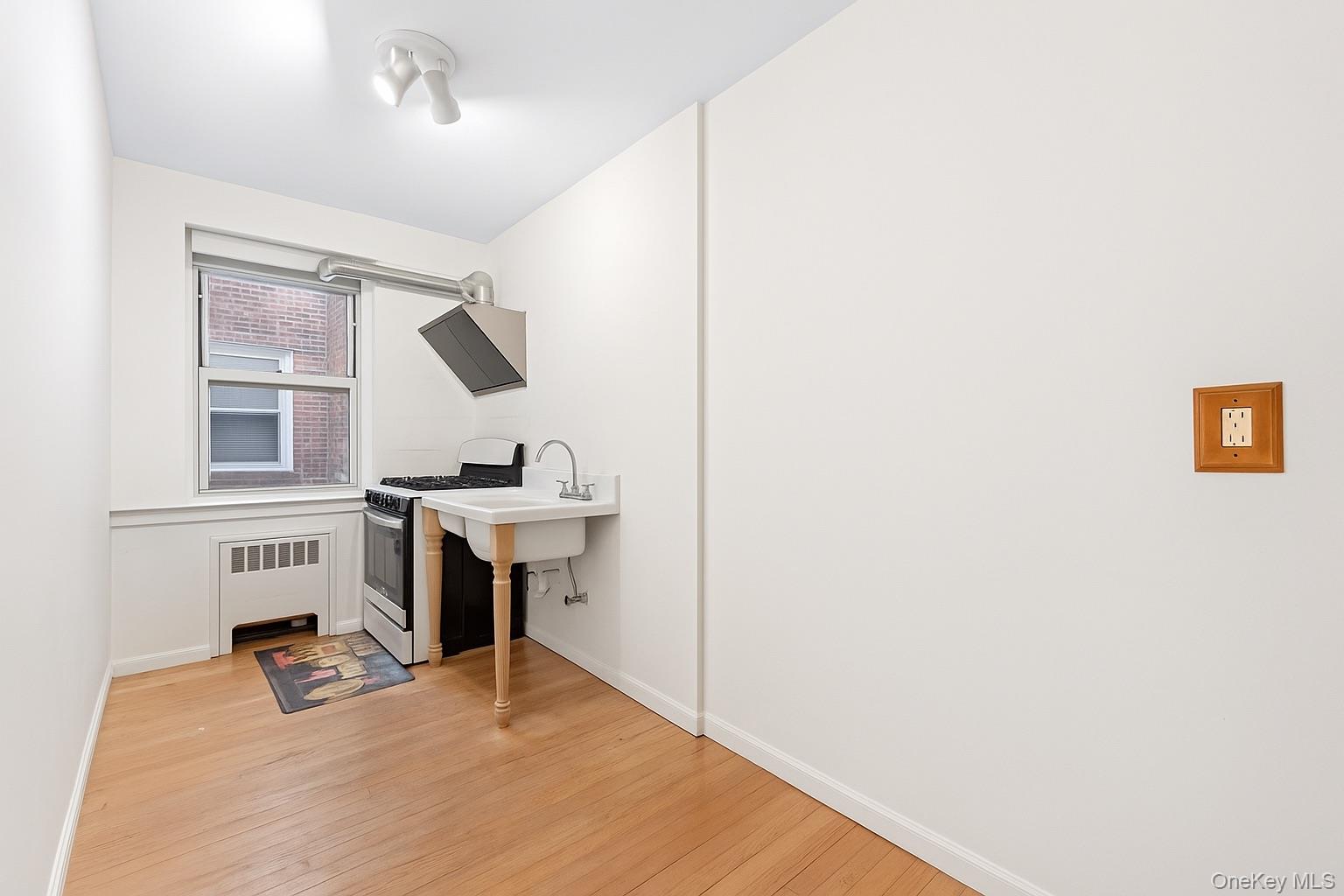 84-35 Lander Street, Unit 2B Queens, NY 11435 - Photo 7 of 16 a room with furniture and a window