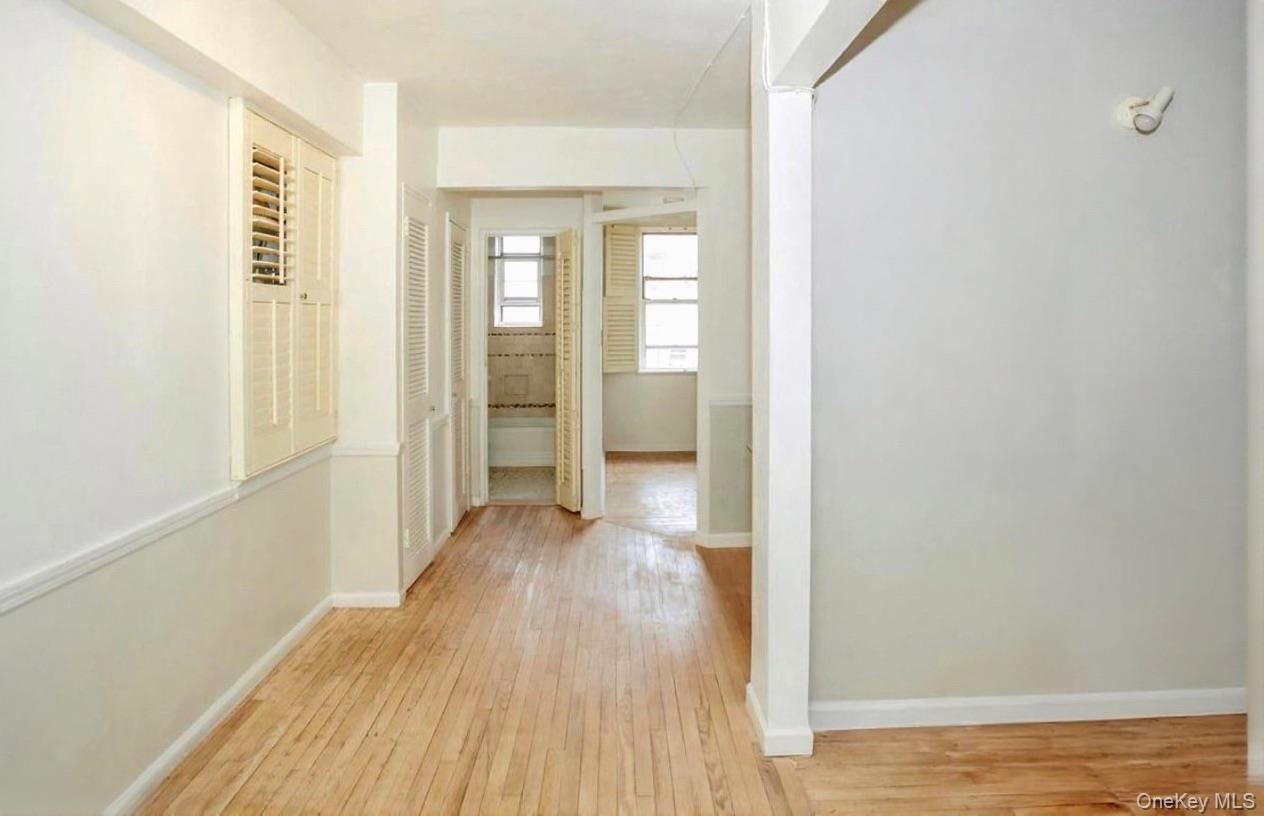 84-35 Lander Street, Unit 2B Queens, NY 11435 - Photo 9 of 16 a view of a room with wooden floor and a window