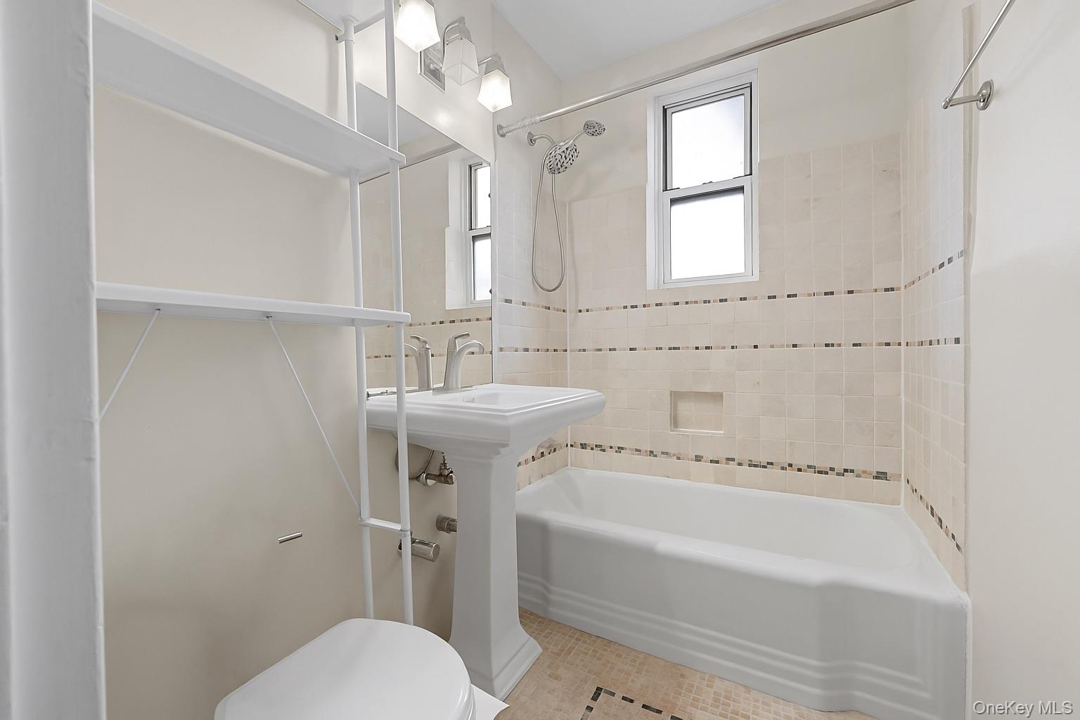 84-35 Lander Street, Unit 2B Queens, NY 11435 - Photo 10 of 16 a bathroom with a sink a toilet and shower