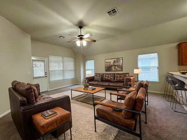 a spacious bathroom with a double vanity sink a mirror and a bathtub