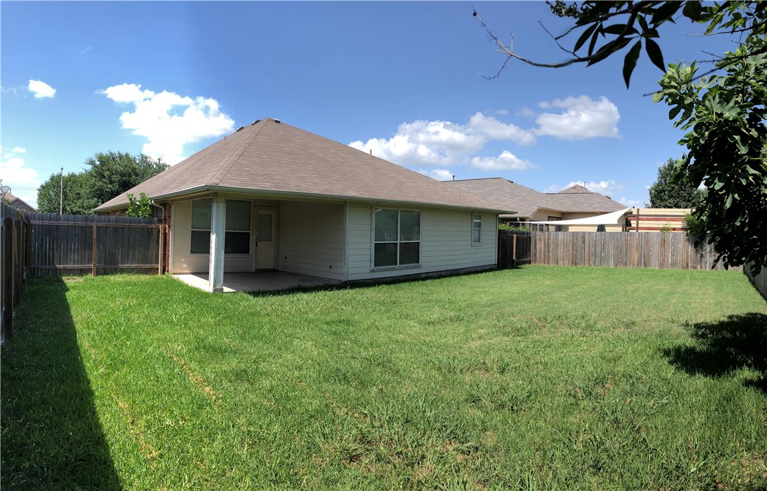 1780 Stone Rim Loop Buda, TX 78610 - Photo 18 of 19 a view of a house with a backyard