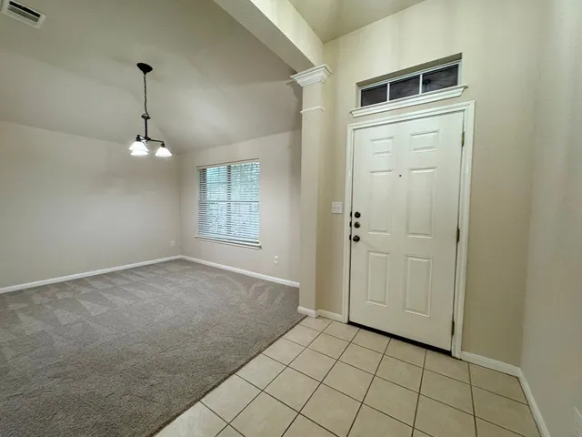 a kitchen with stainless steel appliances granite countertop a stove a sink dishwasher and a refrigerator with wooden floor