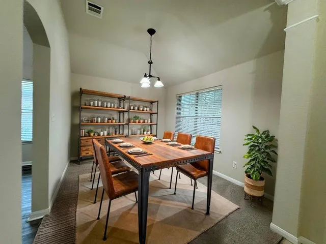 a view of a livingroom with a ceiling fan and window