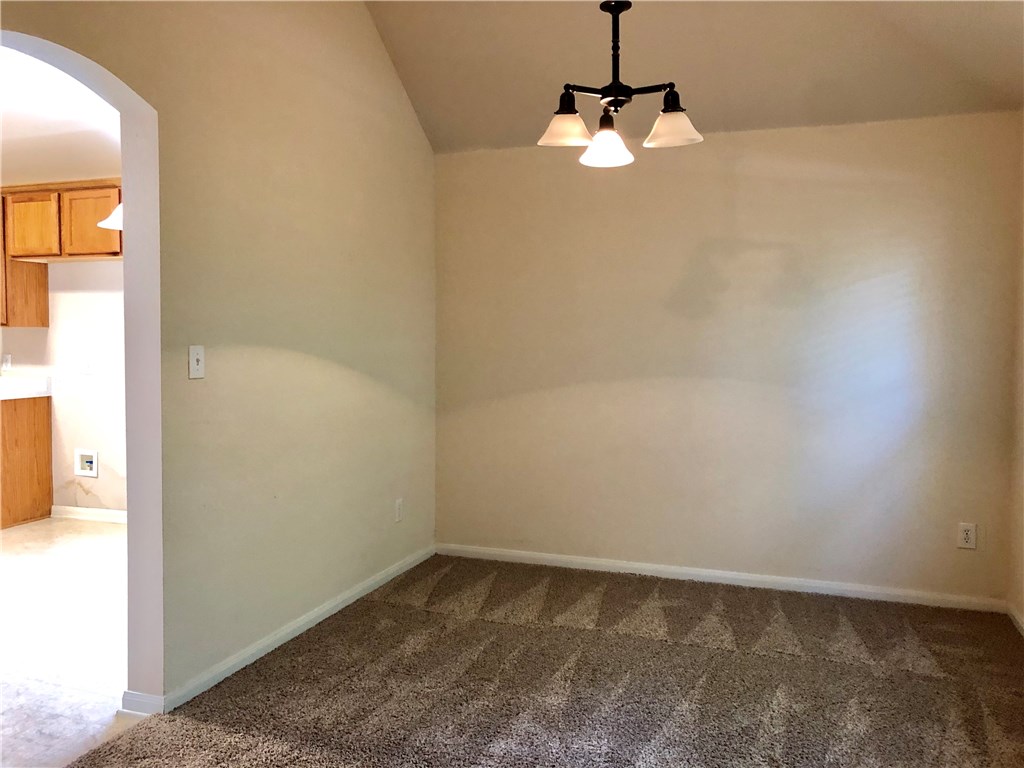 1780 Stone Rim Loop Buda, TX 78610 - Photo 3 of 19 a view of a room with a hanging light and kitchen view