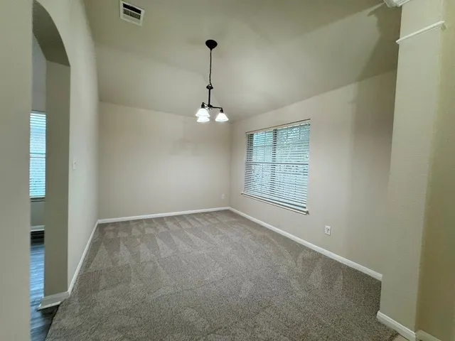 a living room with furniture a ceiling fan and a window
