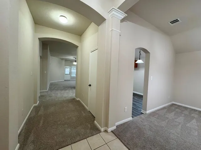 a view of a kitchen with a sink and a chandelier fan