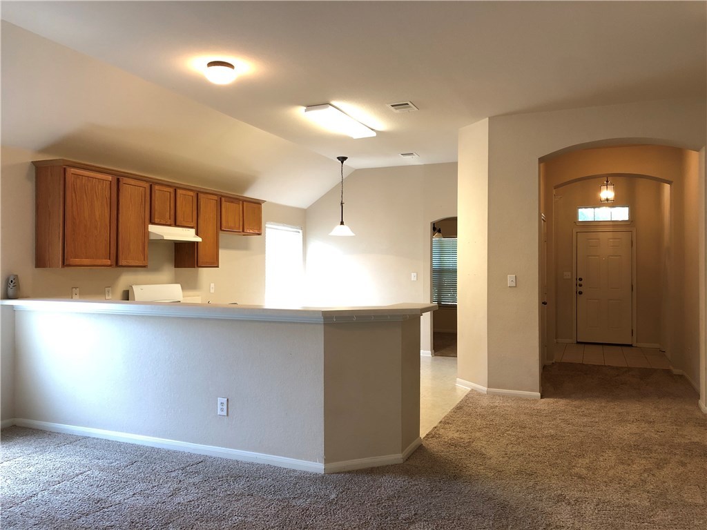 1780 Stone Rim Loop Buda, TX 78610 - Photo 6 of 19 a kitchen with stainless steel appliances granite countertop a refrigerator and a sink