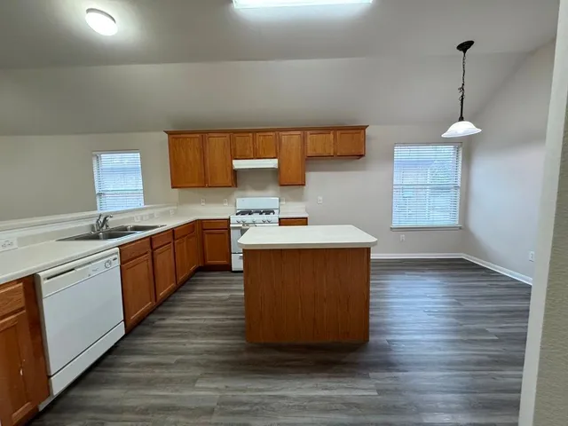a view of a kitchen with a sink and a window