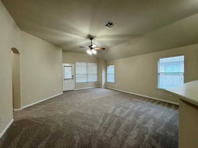 a view of an empty room with a fireplace