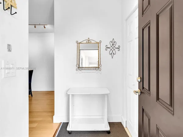 a view of kitchen with furniture and refrigerator