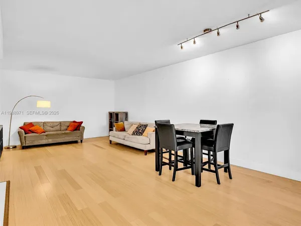 a view of a dining room with furniture and wooden floor