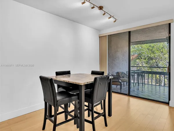 a kitchen with granite countertop a sink and refrigerator