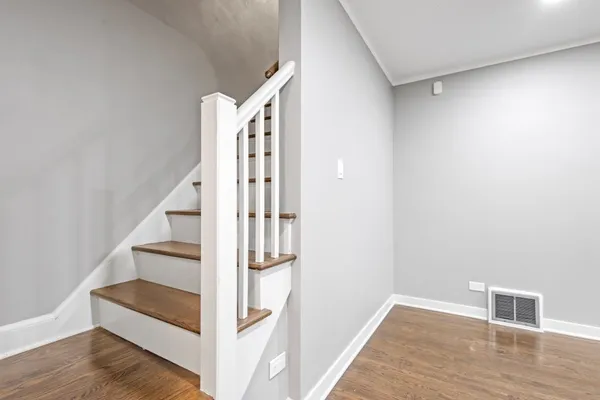 a view of entryway and hall with wooden floor