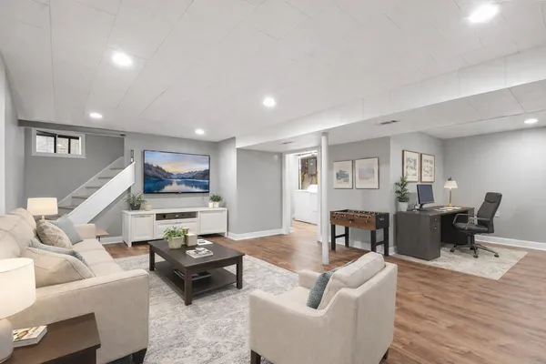 a living room with furniture and a wooden floor
