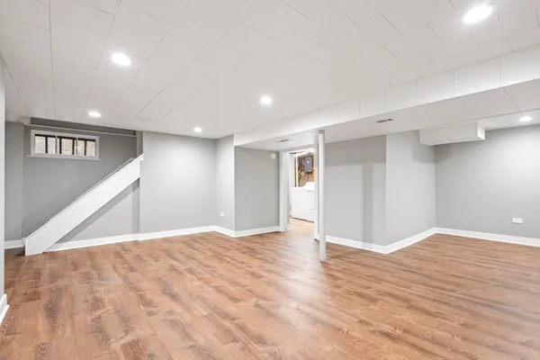 a view of an empty room with wooden floor