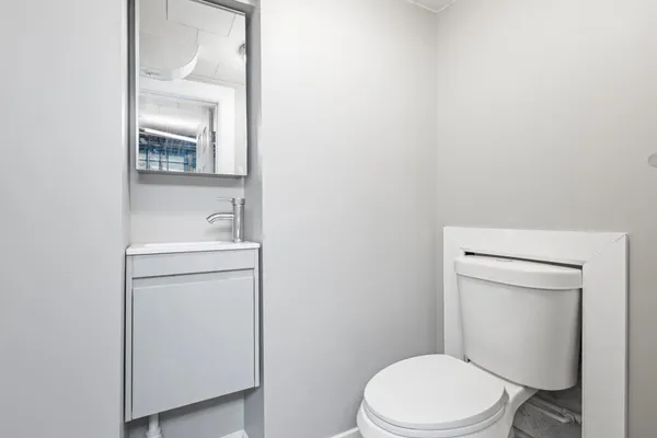 a white toilet sitting next to a bathroom sink