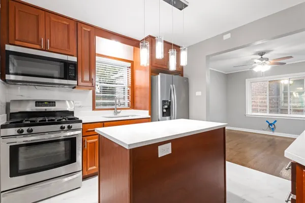 a kitchen with stainless steel appliances a stove a sink and a microwave