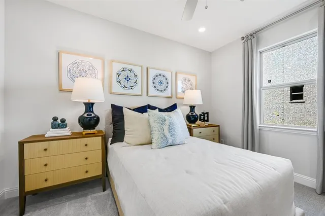 a living room with furniture a table and a large window