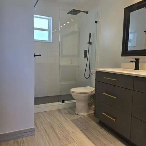 a bathroom with a toilet sink and shower