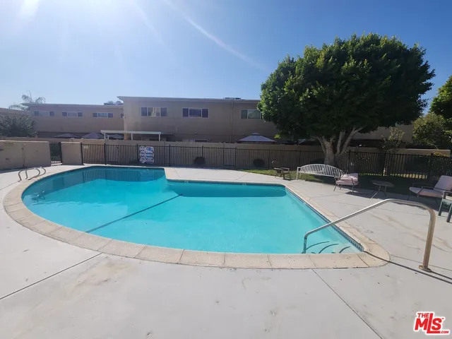 a view of a swimming pool with a yard
