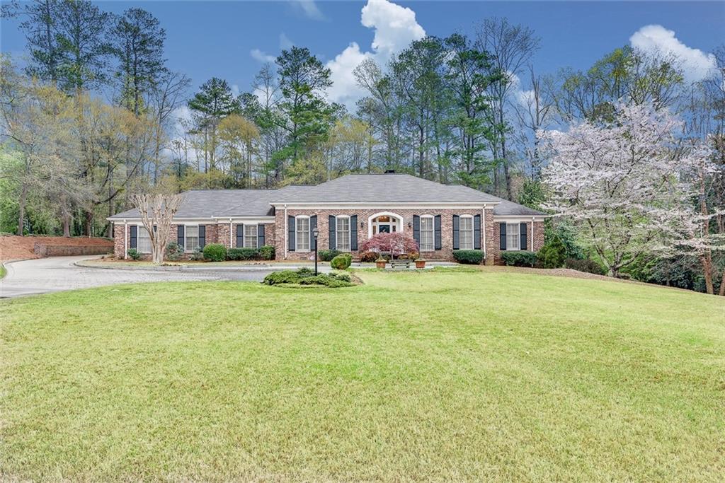 4207 Sentinel Post Road Northwest Atlanta, GA 30327 - Photo 1 of 1 All brick traditional ranch rests on an acre plus property.