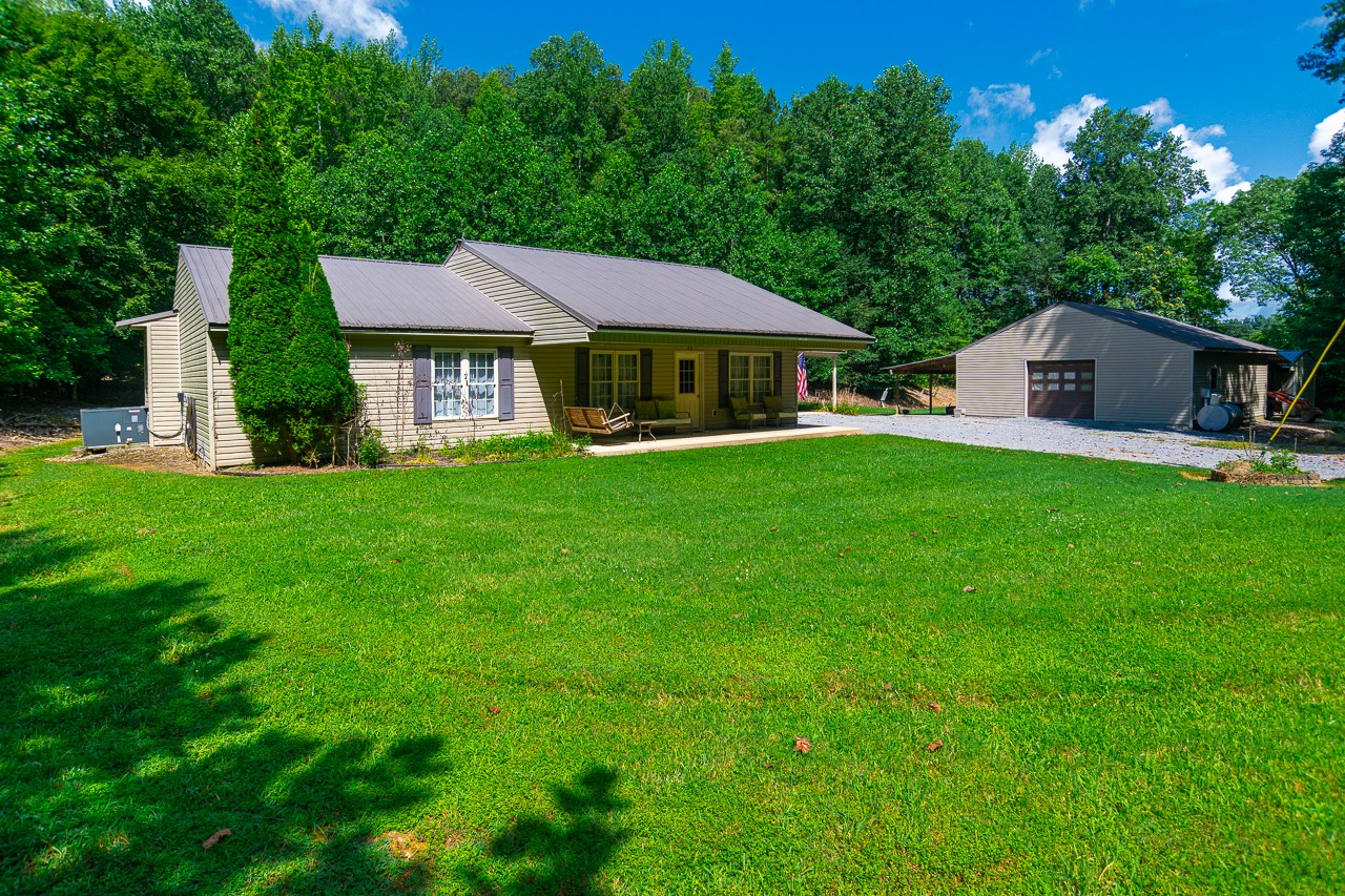 144 North Howard Fitch Road Kelso, TN 37348 - Photo 1 of 59 a view of a house with a big yard potted plants and large tree