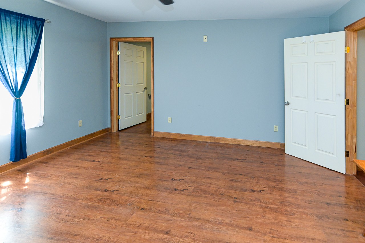 144 North Howard Fitch Road Kelso, TN 37348 - Photo 33 of 59 a view of an empty room with wooden floor and a window