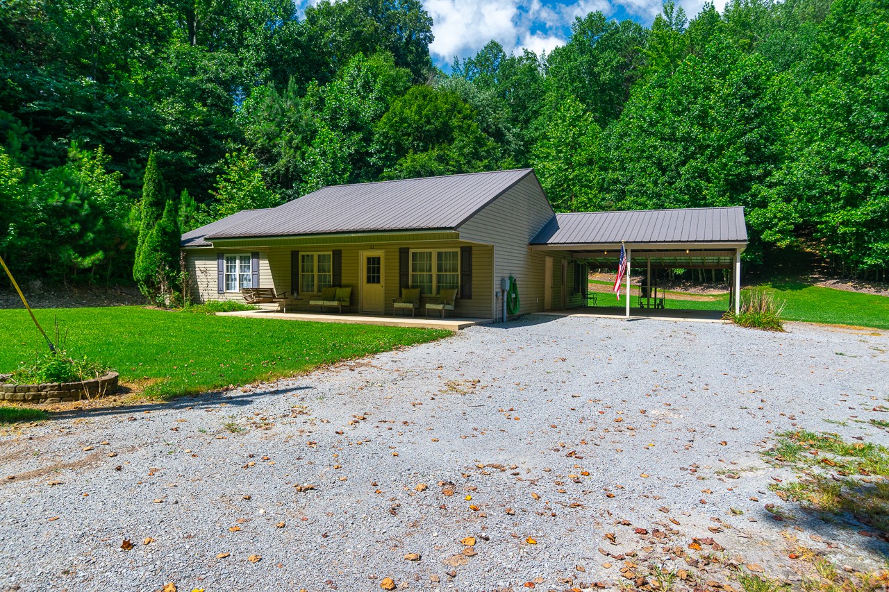 144 North Howard Fitch Road Kelso, TN 37348 - Photo 4 of 59 a house with a yard and a large tree