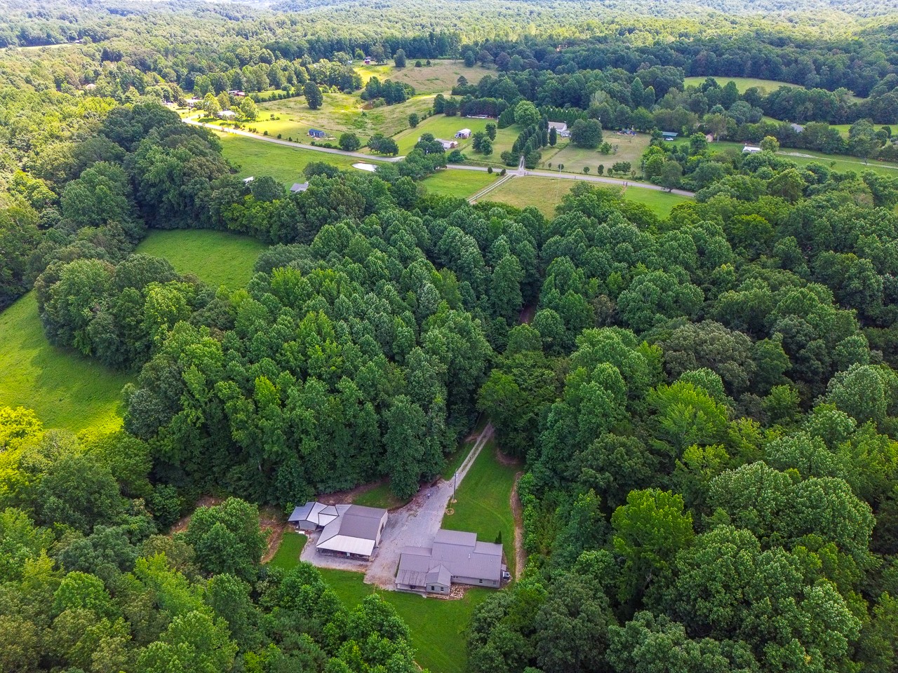 144 North Howard Fitch Road Kelso, TN 37348 - Photo 54 of 59 an aerial view of residential houses with outdoor space and trees