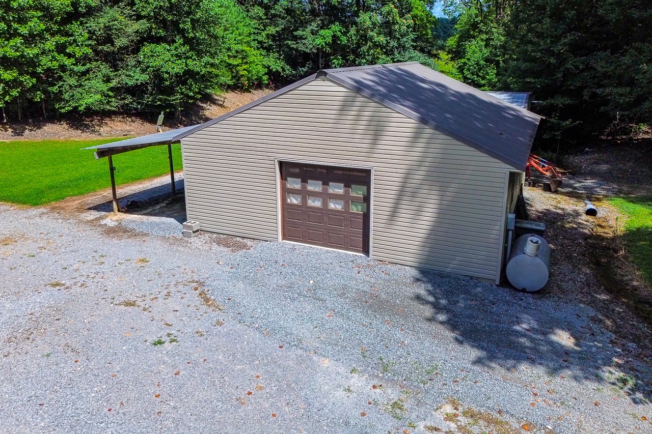 144 North Howard Fitch Road Kelso, TN 37348 - Photo 56 of 59 a view of a house with a yard and a garage