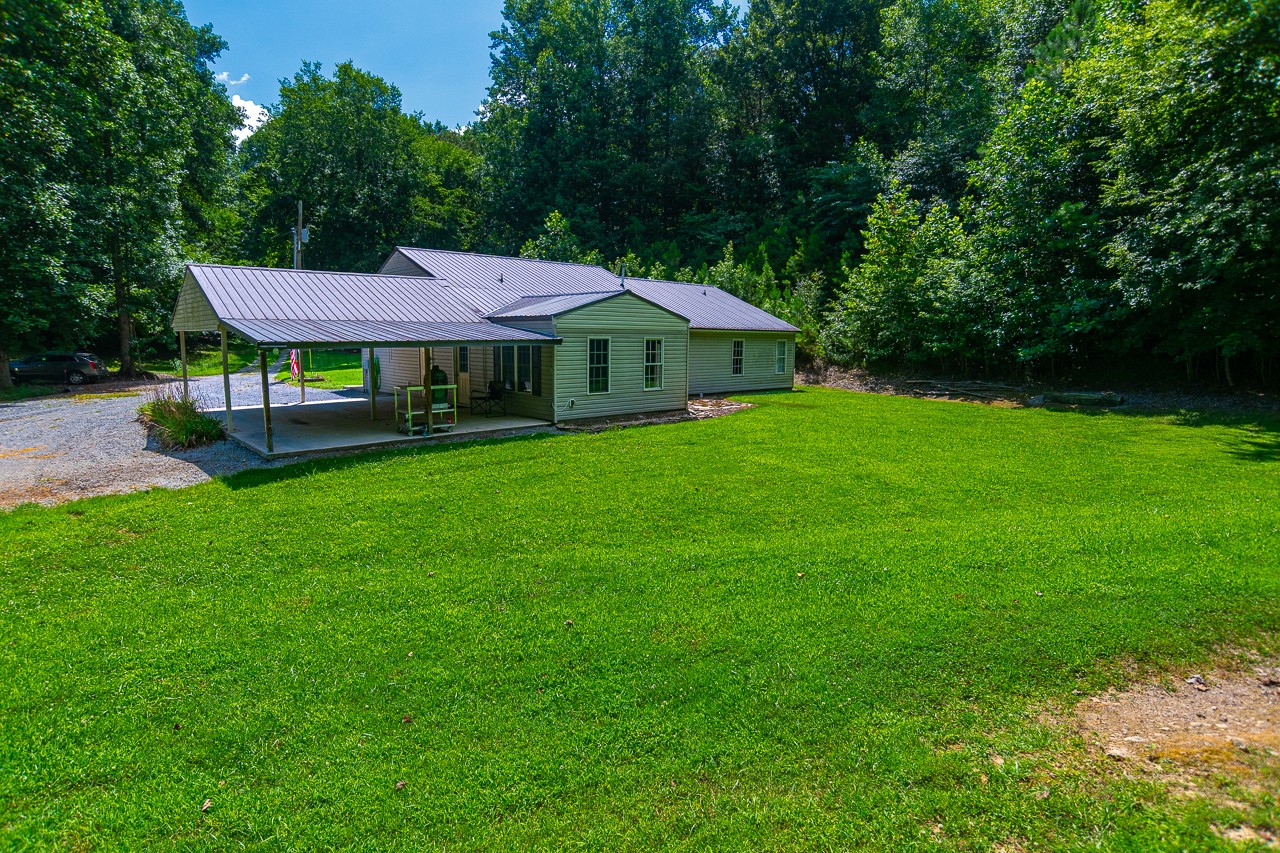 144 North Howard Fitch Road Kelso, TN 37348 - Photo 6 of 59 a front view of a house with garden