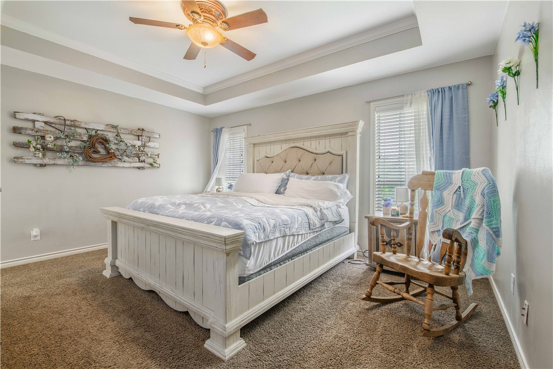 6538 Olympia Buddy Road College Station, TX 77845 - Photo 20 of 50 a bedroom with a bed a chair and a chandelier