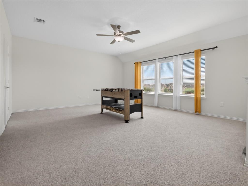 636 Corner Post Path Celina, TX 75009 - Photo 26 of 40 Spacious room featuring light-colored carpet flooring, multiple windows with blinds, a ceiling fan, and painted white walls