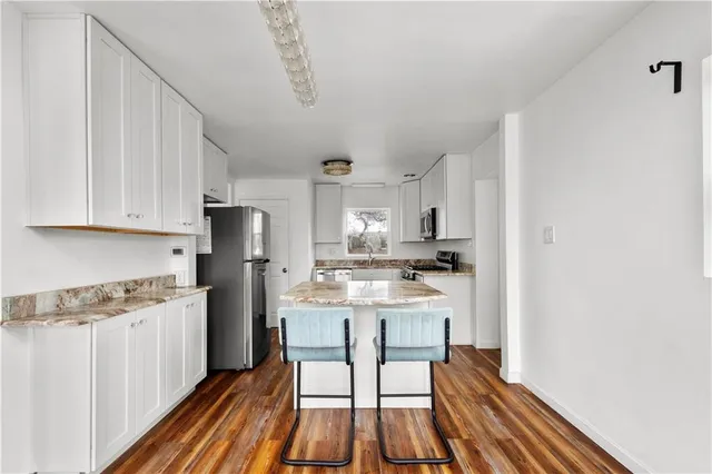 a kitchen with stainless steel appliances a stove a sink dishwasher and a refrigerator