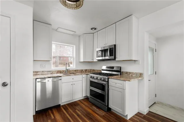 a kitchen with a stove a sink and a microwave