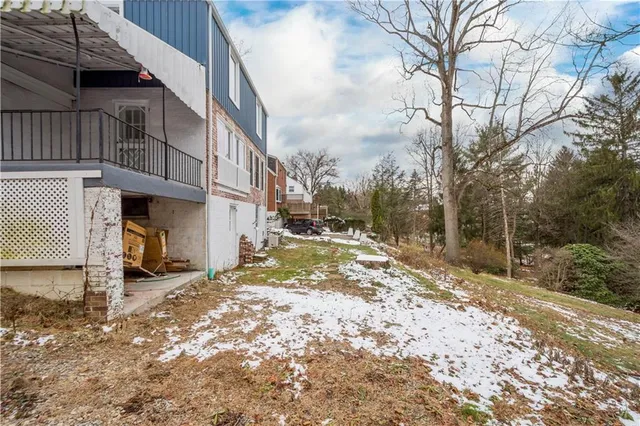 a view of a house with a snow in the yard